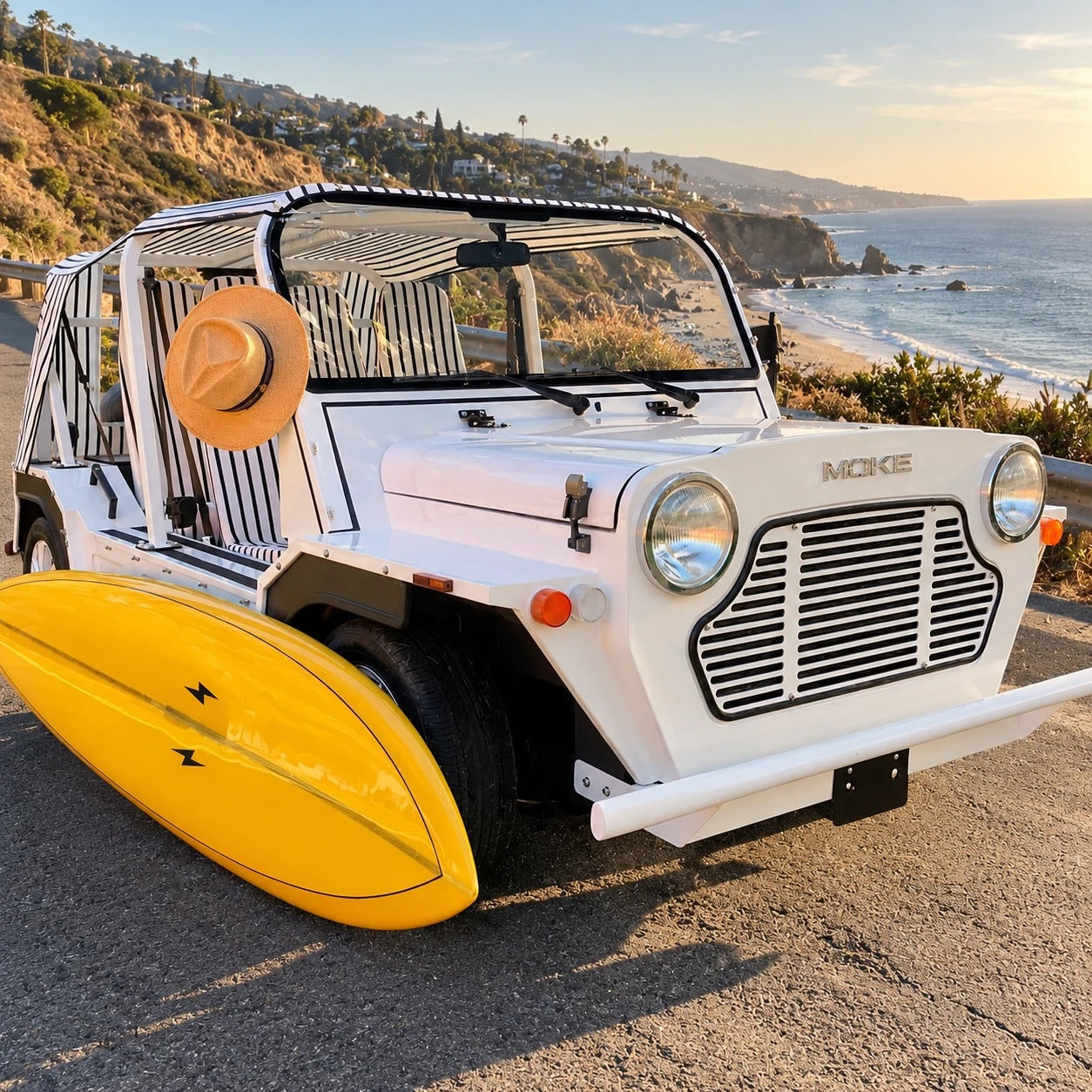 A white Moke with a yellow surfboard on the coast road above Malibu