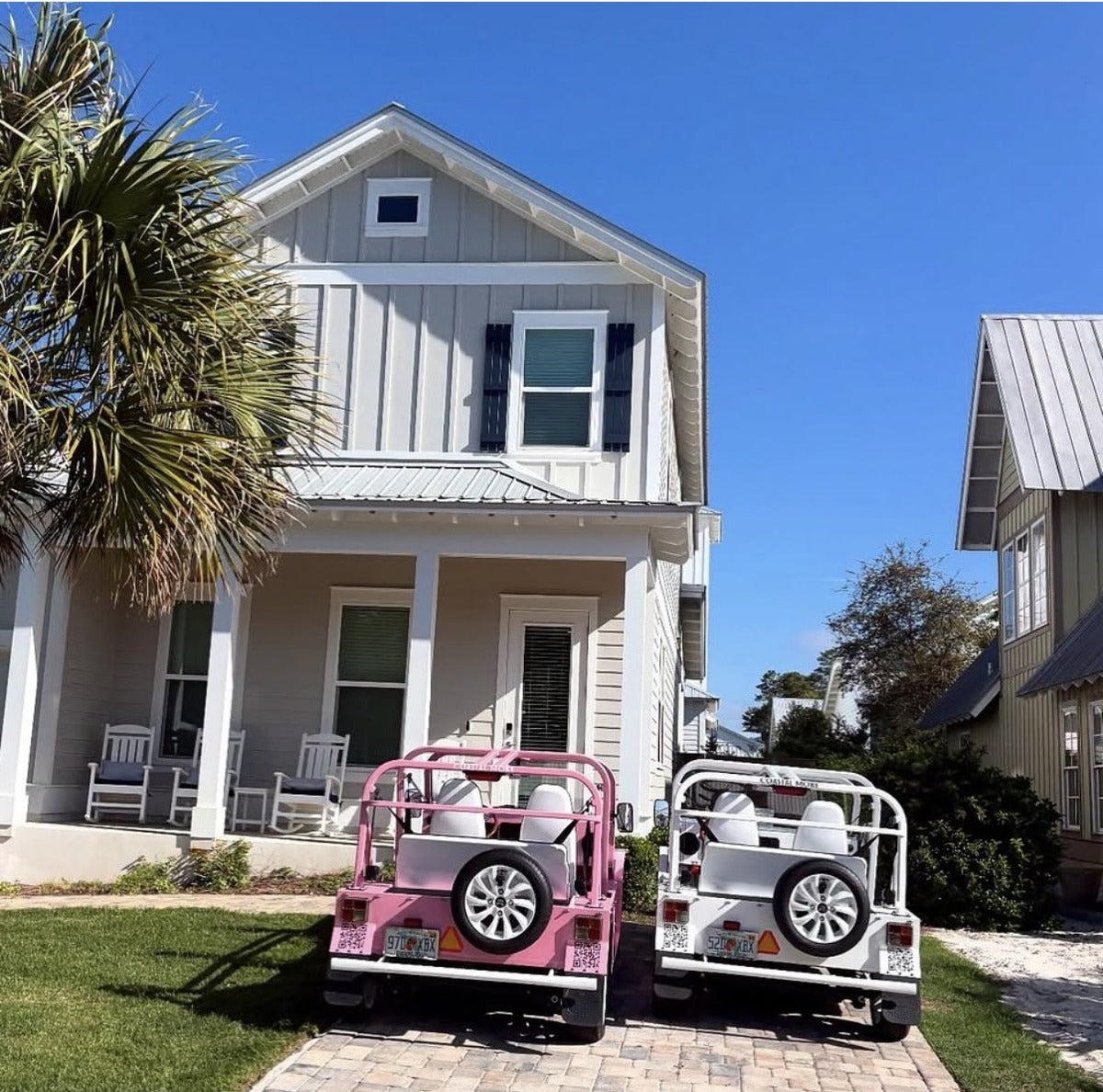 Two Mokes parked outside a coastal Florida home