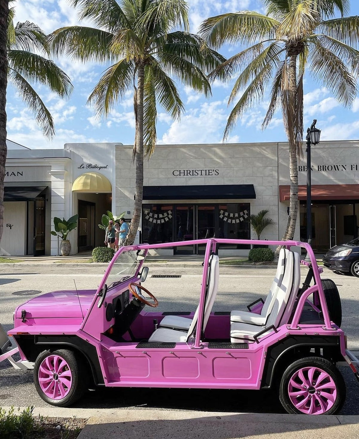 A pink Moke parked outside the shops on Worth Avenue